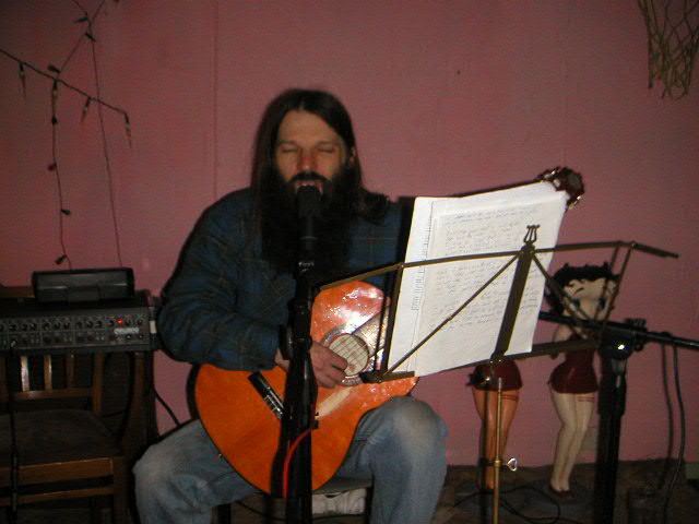 Singer Alan Robinson aka Jesus playing at the Variety Club radford Nottingham with a bearded long haired manekin on the side of the stage painted with a black eye